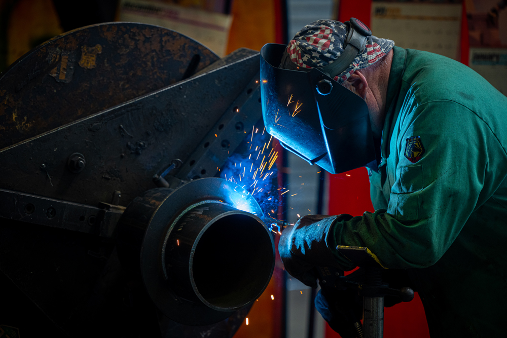 Certified welders at Herman Goldner Co., Inc. performing high-precision TIG welding on stainless steel piping for mechanical and process systems.