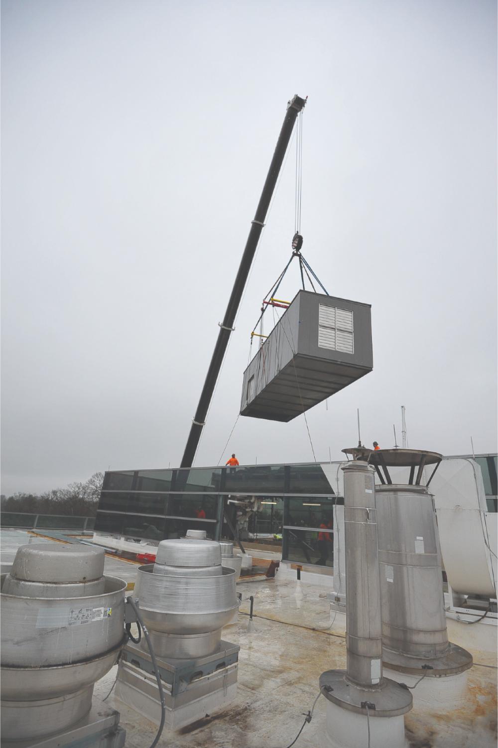 Crane lifting a 45,000 CFM Carrier AHU onto a Philadelphia rooftop