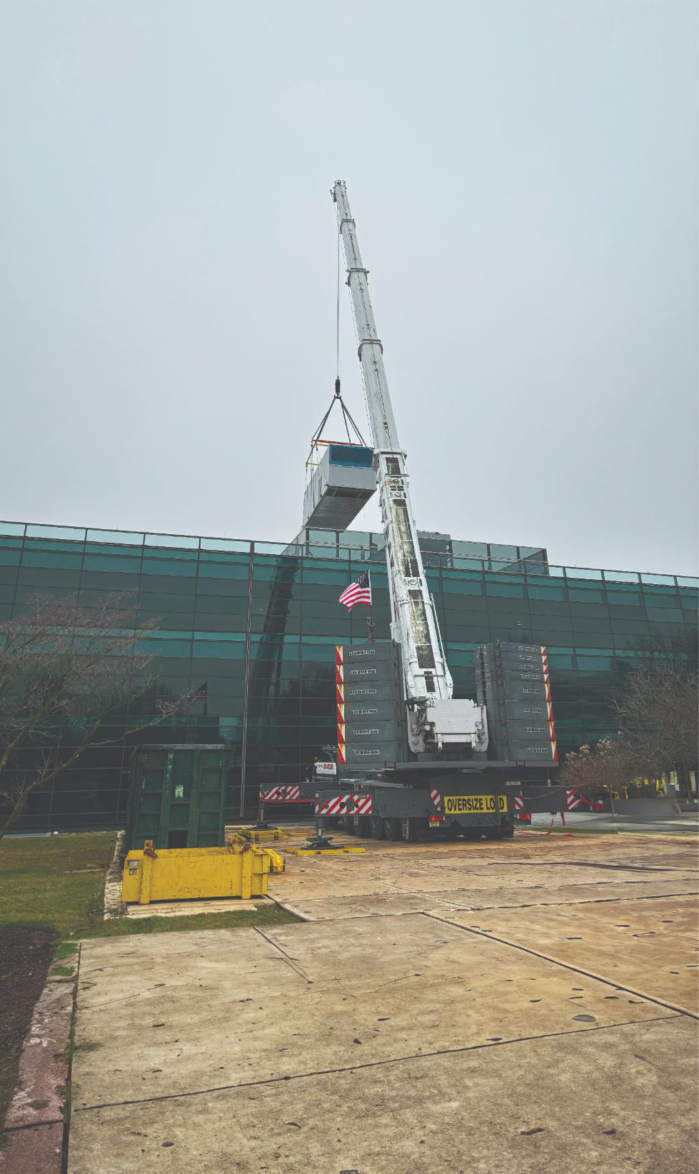 Crew guiding a Carrier air-handling unit into position during the SAP replacement