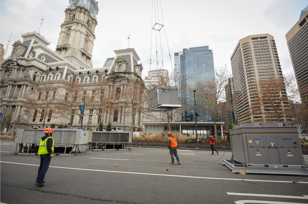 Street-level view looking toward 1234 Market Street and City Hall during helicopter lift operations
