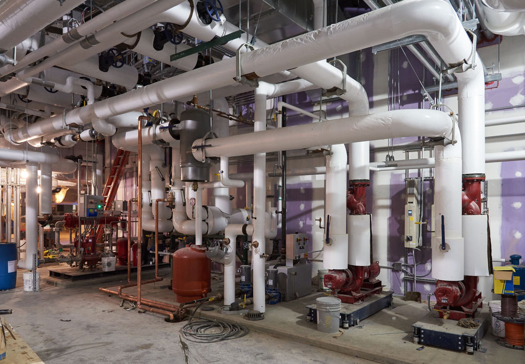 Mechanical room with new piping, valves, insulation, and medical gas lines