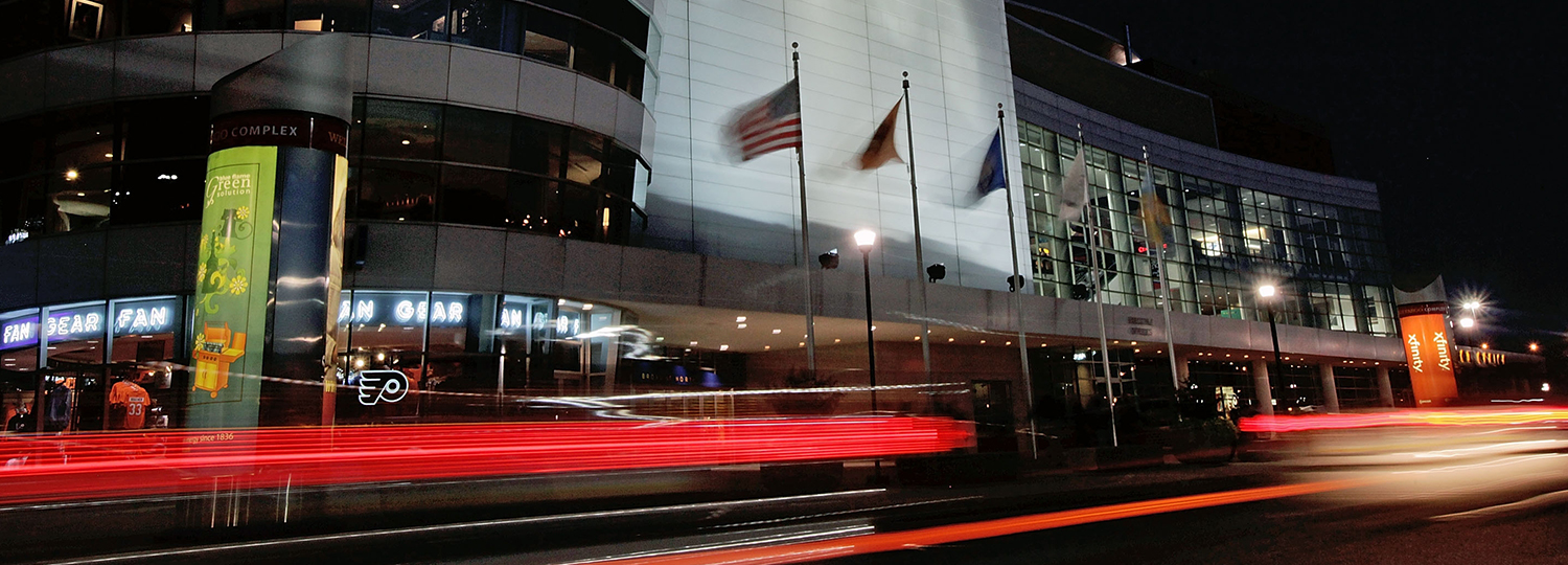 Wells Fargo Center exterior at night with arena signage—project spotlight on building automation conversion