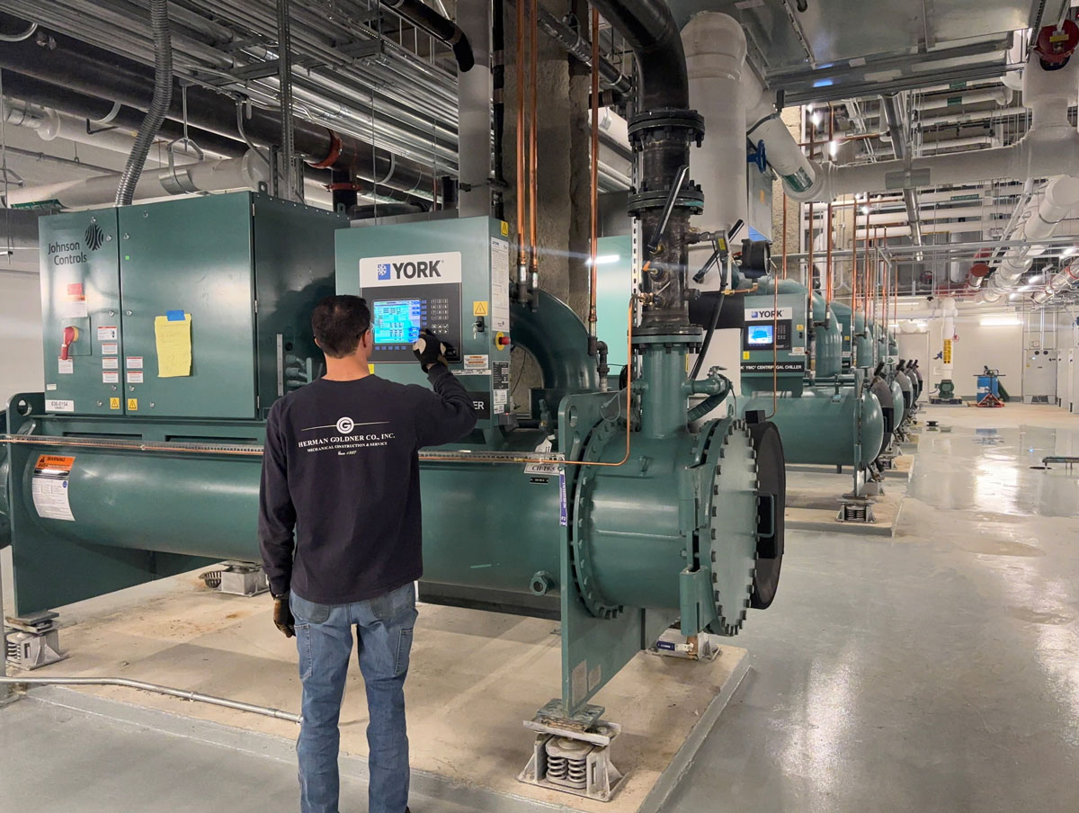 Certified technician from Herman Goldner Co., Inc. servicing commercial chillers and boilers to optimize performance and reduce downtime.