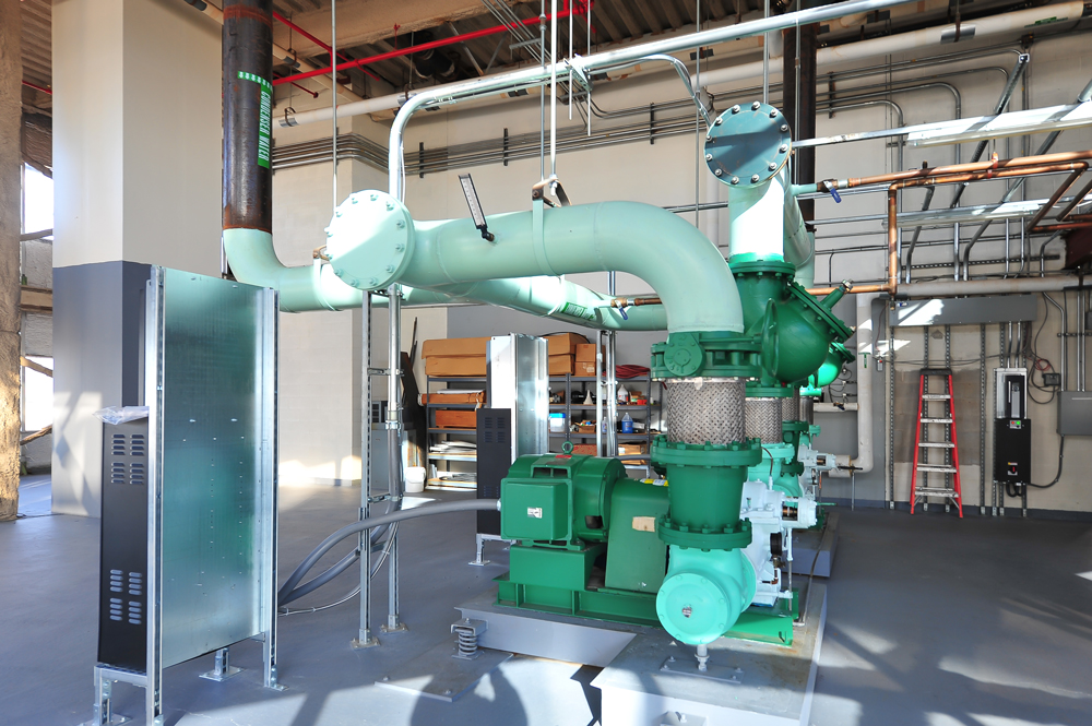 Completed mechanical room installation by Herman Goldner Co., Inc. featuring prefabricated piping, chillers, and energy-efficient HVAC systems.