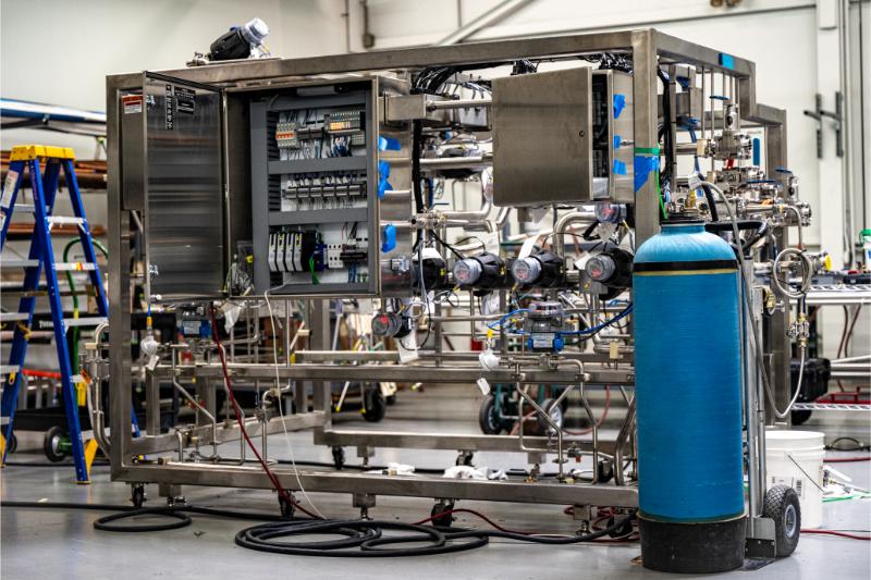 Custom process skid fabricated and wired by Herman Goldner Co., Inc., featuring integrated valves, pumps, and control panels for sanitary piping applications.