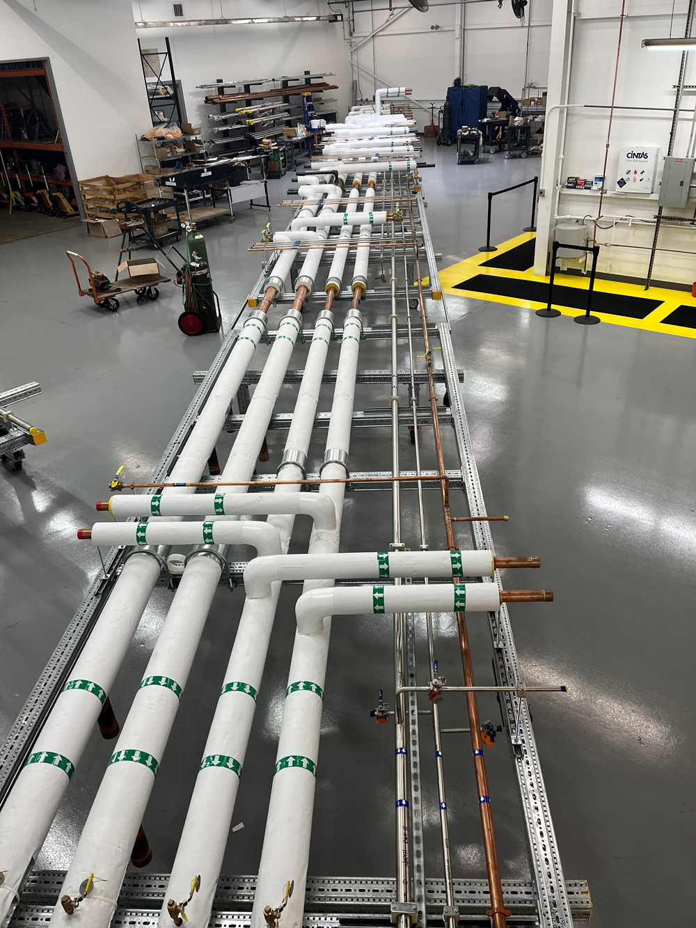 Modular rack fabrication area at Herman Goldner Co., Inc. showing preassembled HVAC and mechanical pipe racks.