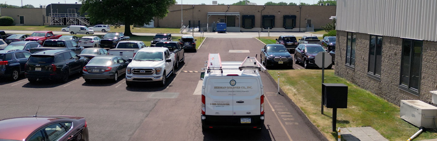Herman Goldner Co., Inc. service van departing company headquarters in Philadelphia, representing comprehensive mechanical services.