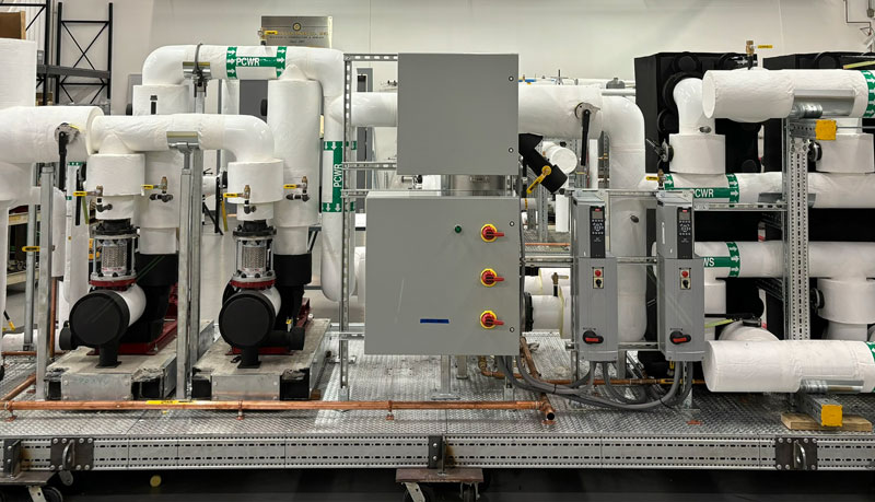 Prefabricated skid assembly with pumps and piping built by Herman Goldner Co., Inc. for modular mechanical room applications.