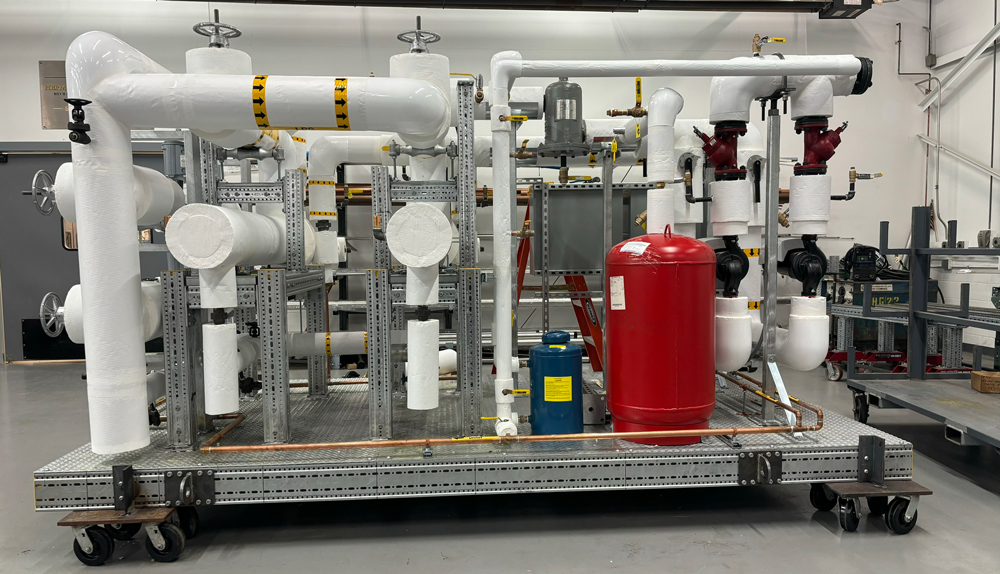 Prefabricated skid assembly with pumps and piping built by Herman Goldner Co., Inc. for modular mechanical room applications.